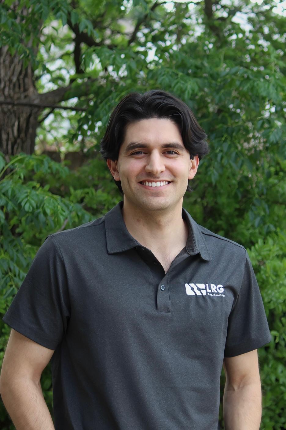 David Tapia, E.I.T. in a black polo outdoors